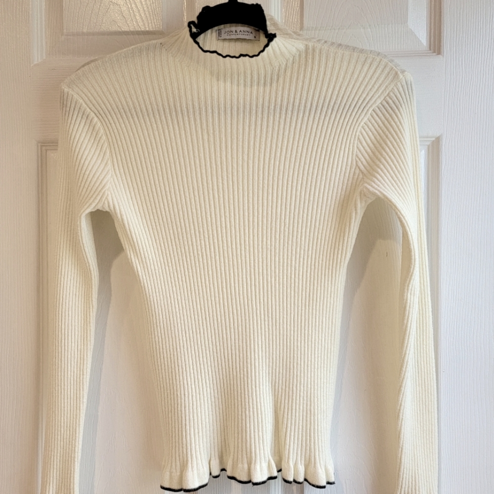 Jon & Anna Contemporary ribbed cream sweater with black ruffle trim.